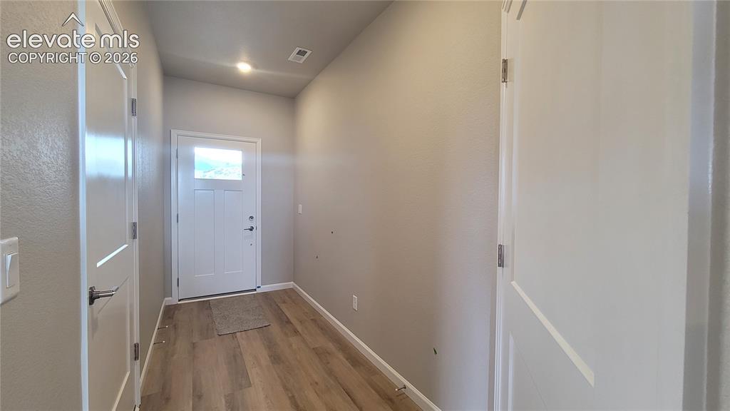 Image 3 of 32: Welcome Home! Inviting entryway with LVP flooring, garage access, utility c