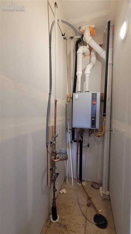 Image 30 of 32: Utility closet on entry level with a tankless water heater! 