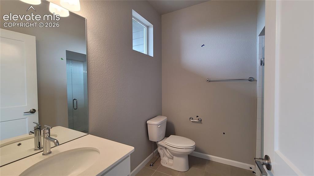Image 6 of 32: 3/4 Bathroom with quartz countertop and tile surrounds!