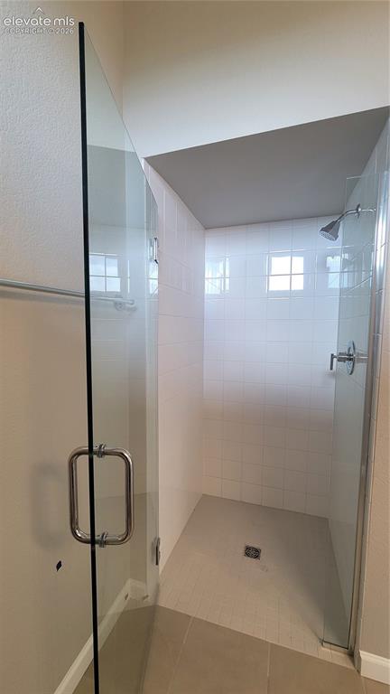 Image 7 of 32: Zero entry shower with tile surround at Junior suite bathroom!