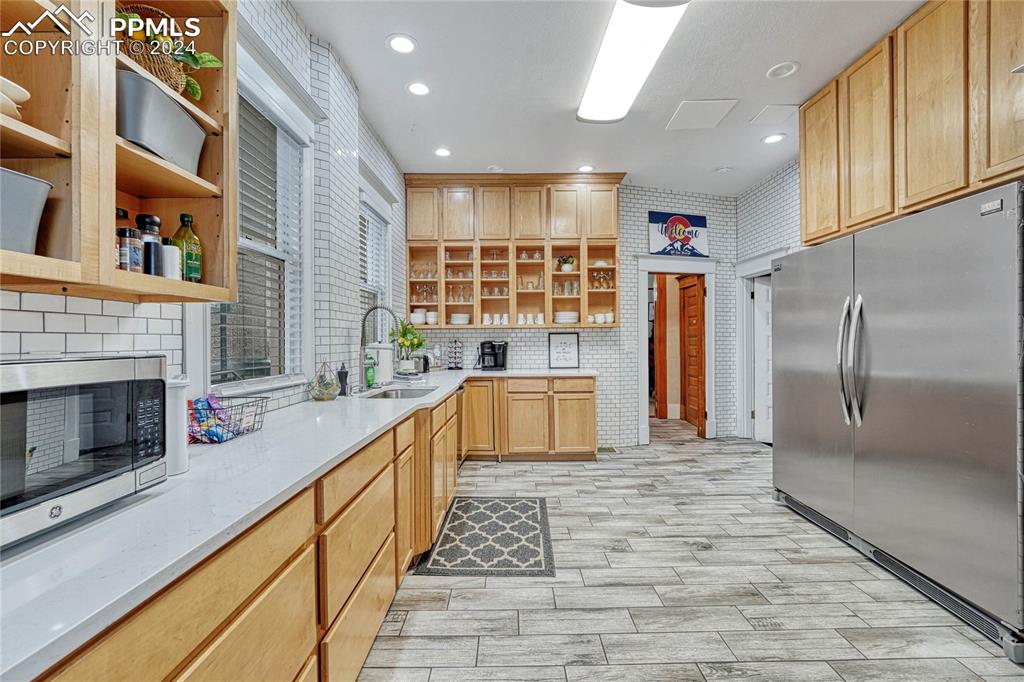 Image 14 of 50: Kitchen, Tile Floor, Wooden Cabinets
