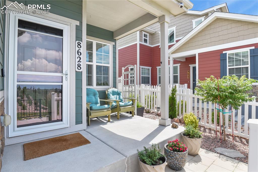 Image 2 of 20: Charming front patio with roll up privacy screen!