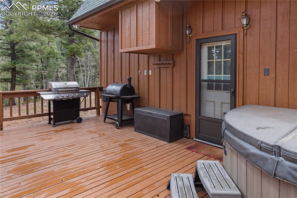 Image 18 of 39: Main Level Back Deck & Hot Tub