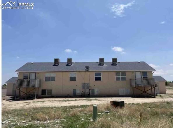 Image 2 of 8: Back of house featuring central air condition unit