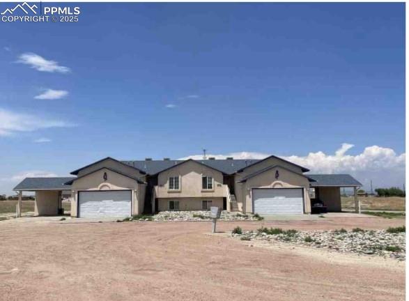 Image 8 of 8: View of front of property featuring a garage