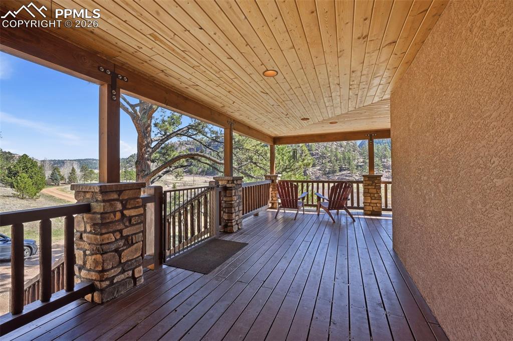 Image 10 of 50: Enter the property through a captivating wrap-around covered front porch.