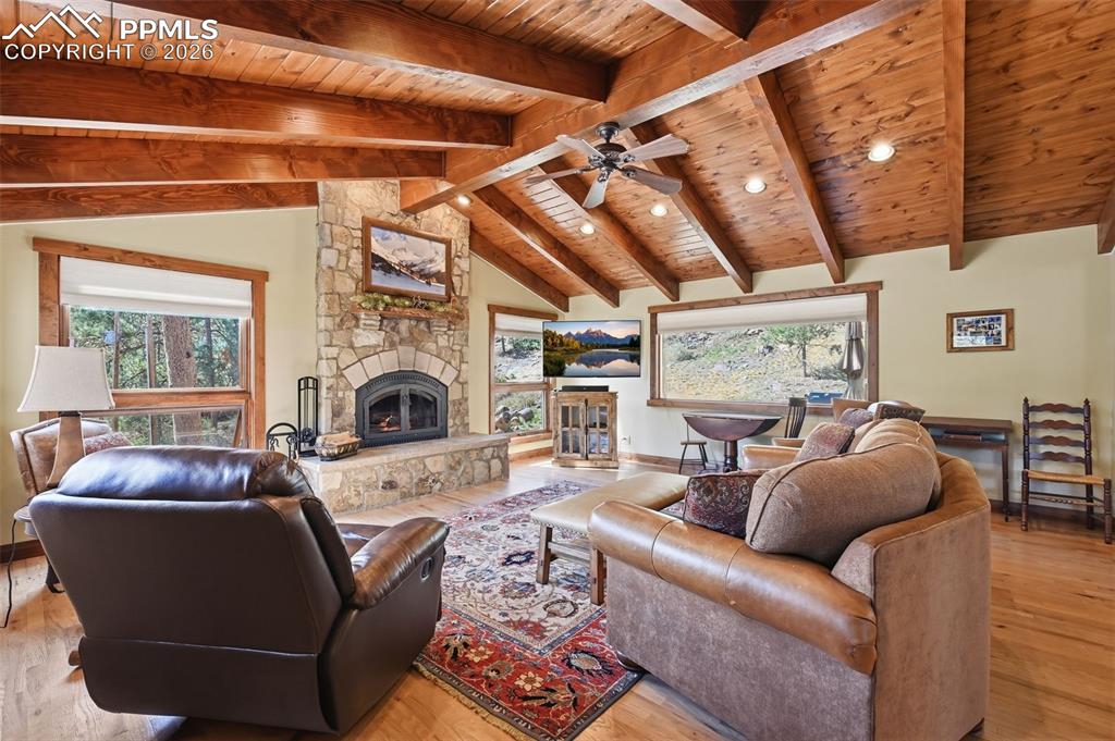 Image 13 of 50: The first of two captivating fireplaces on this level, this wood-burning fi