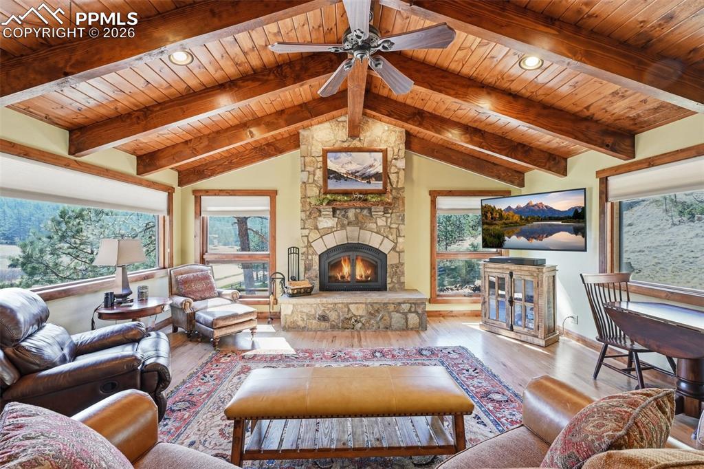 Image 14 of 50: Soaring cathedral ceilings and surrounding picture windows perfectly frame