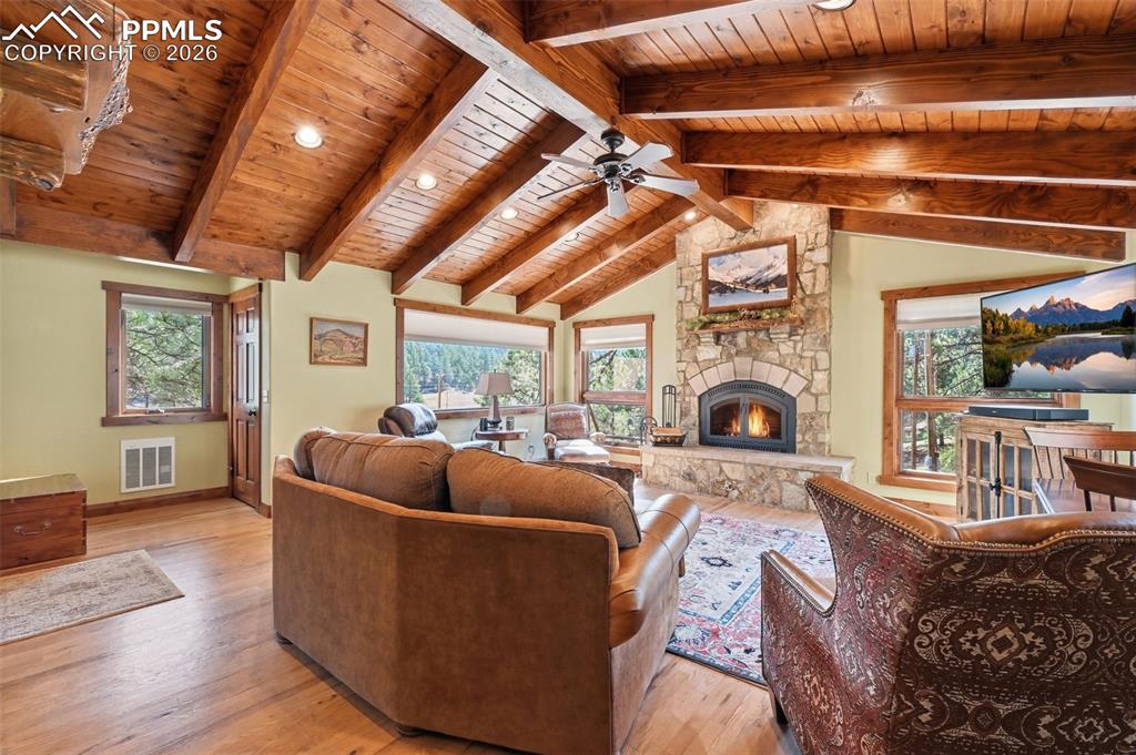 Image 15 of 50: Natural hardwood floors compliment the exquisite ceiling, creating a room t