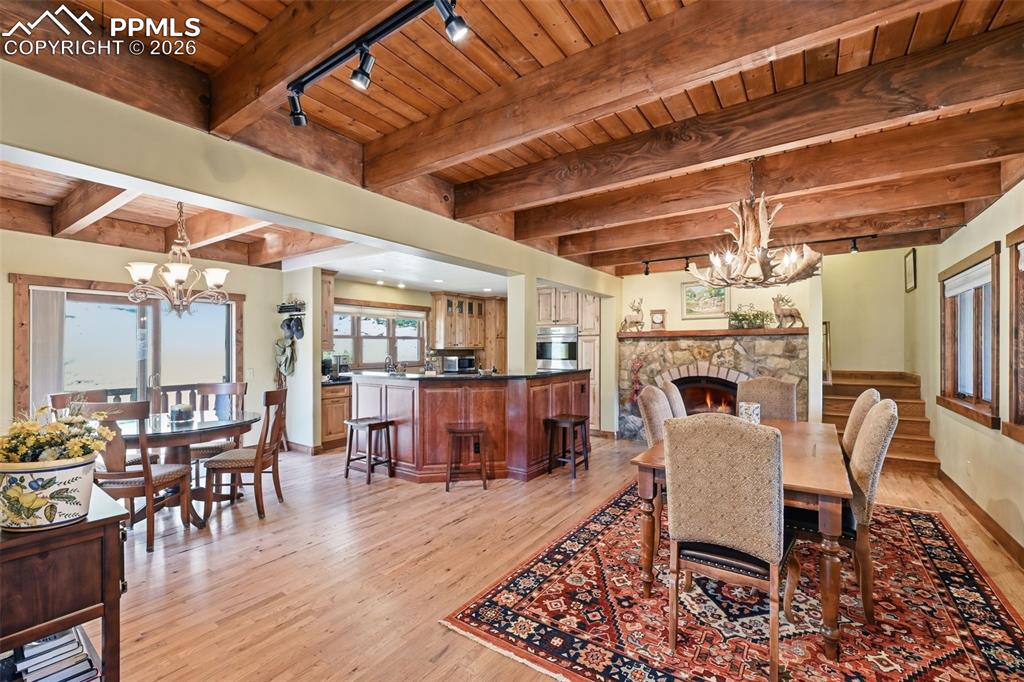 Image 16 of 50: Two opposing fireplaces perfectly tie the living room, dining room and kitc