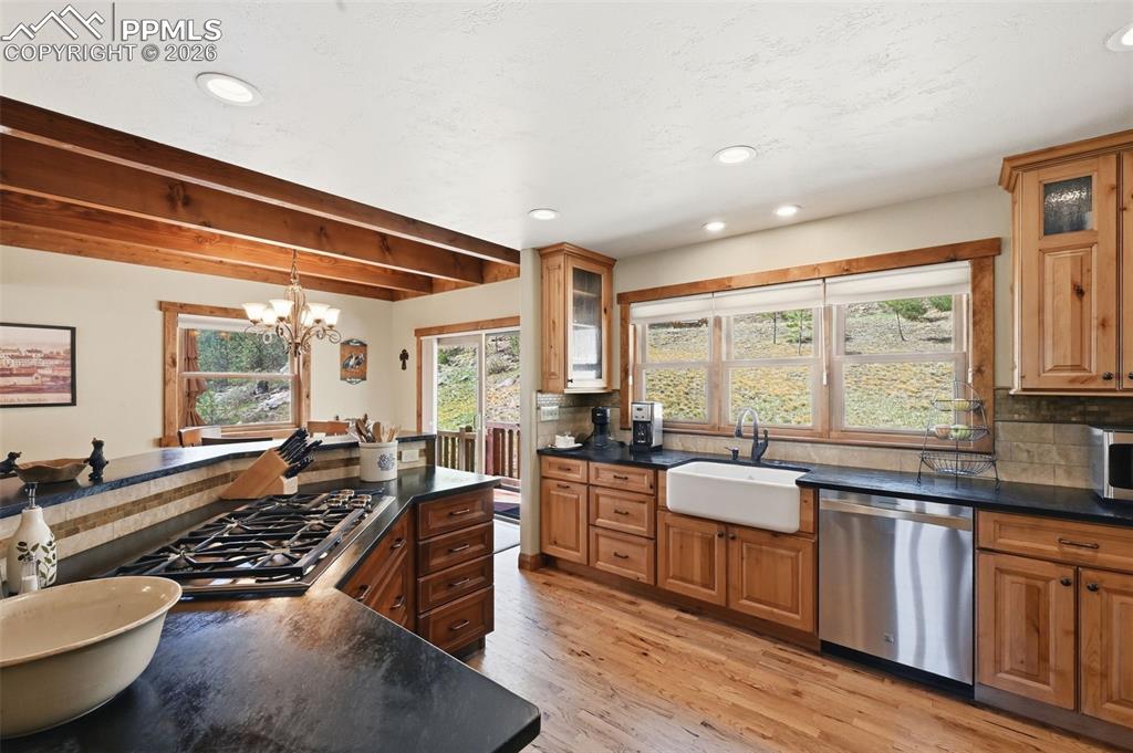 Image 18 of 50: The first of two captivating fireplaces on this level, this wood-burning fi