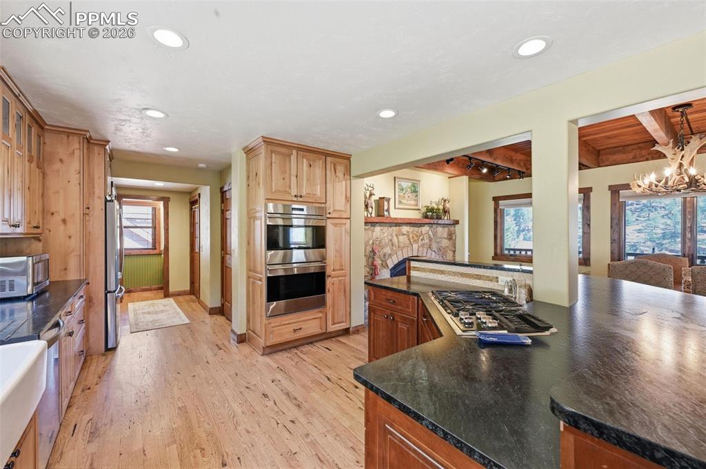 Image 19 of 50: This elegant kitchen hosts a dual ovens, and a propane gas range among othe