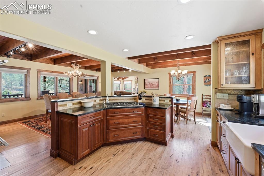 Image 21 of 50: Two opposing fireplaces perfectly tie the living room, dining room and kitc