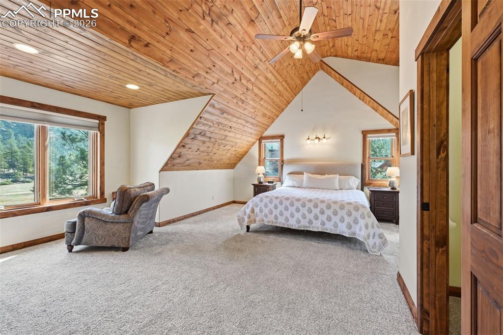 Image 24 of 50: The primary retreat features soaring vaulted ceilings finished with wood ac