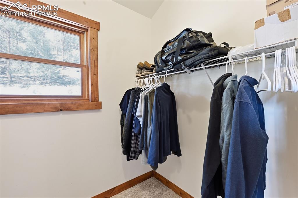 Image 27 of 50: First walk-in closet for the primary retreat.