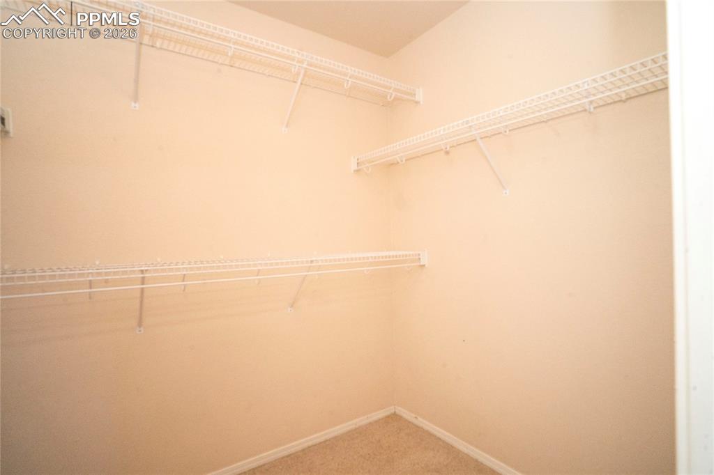 Image 18 of 43: Primary walk-in closet