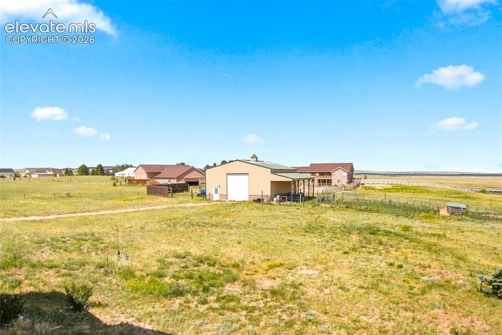 Image 39 of 44: Expansive rural property featuring multiple outbuildings, including a prima