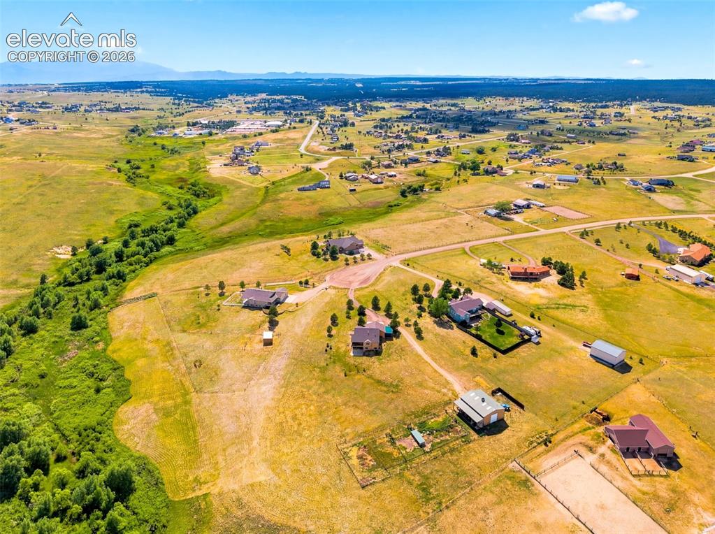 Image 41 of 44: Expansive rural landscape featuring scattered residences, abundant open fie