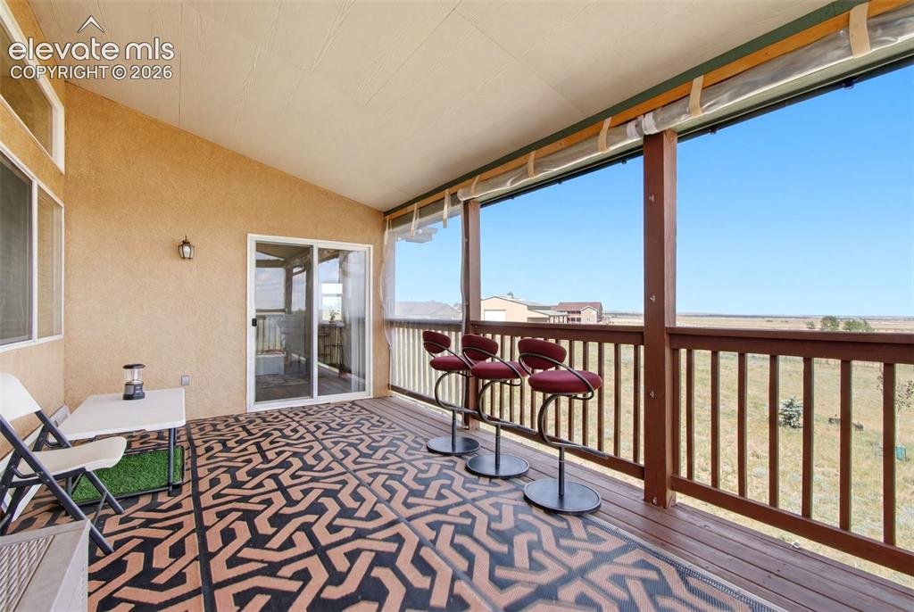 Image 43 of 44: Elevated deck featuring geometric patterned flooring, wood-finish railings,
