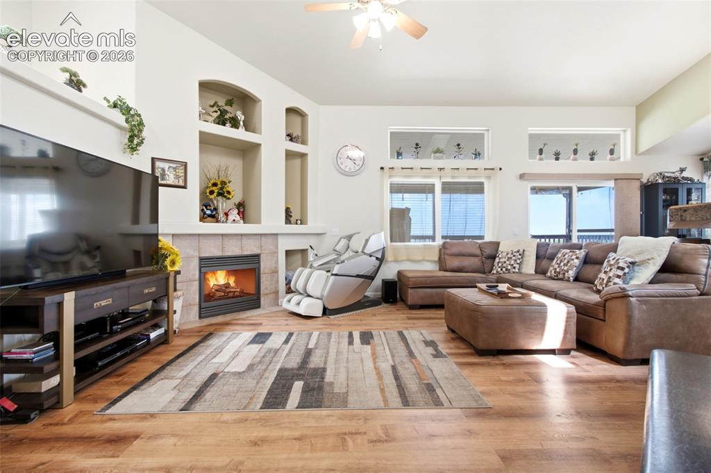 Image 8 of 44: Laminate Wood-finish flooring throughout, featuring a corner gas fireplace 