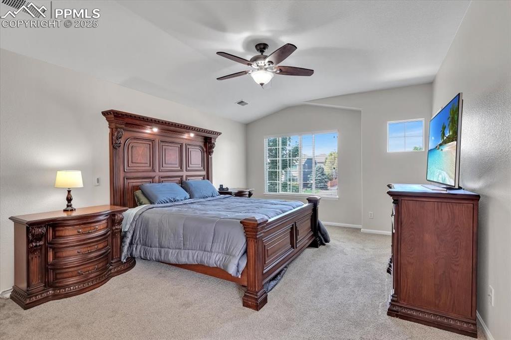 Image 19 of 30: Bedroom featuring light colored carpet, a ceiling fan, and lofted ceiling