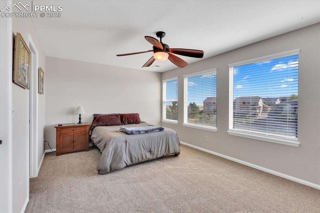 Image 24 of 30: Bedroom featuring light colored carpet and a ceiling fan