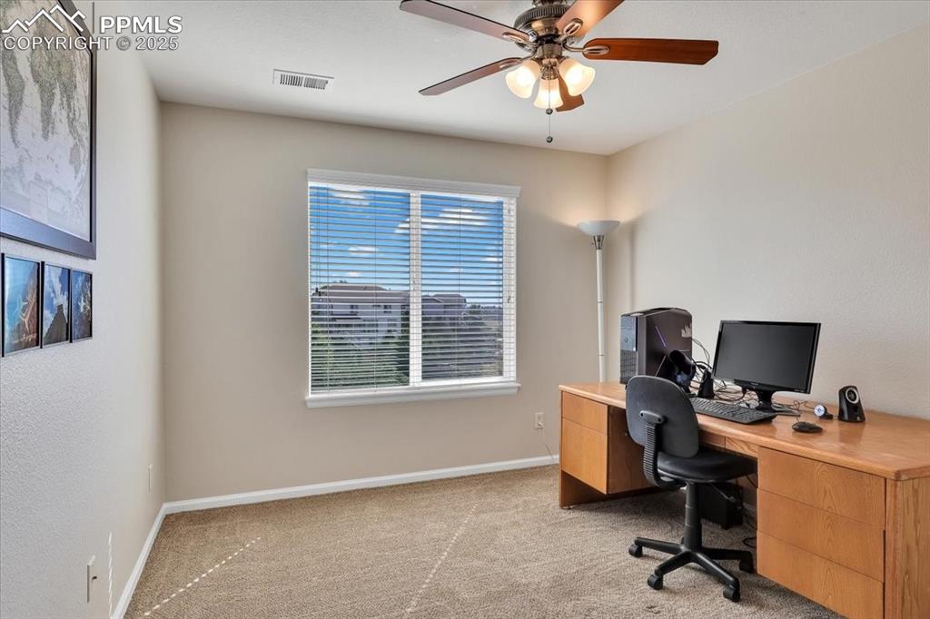 Image 26 of 30: Home office featuring light colored carpet and a ceiling fan