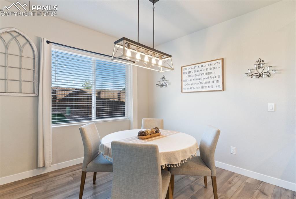 Image 10 of 26: Dining space with baseboards and light wood finished floors