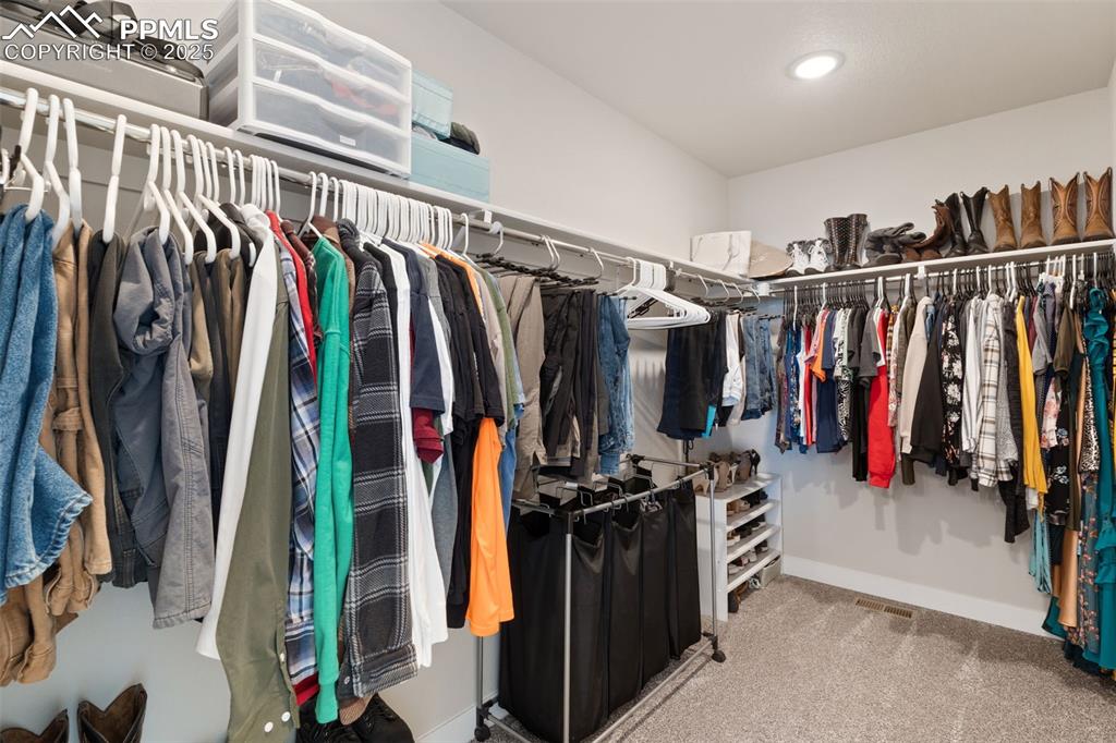 Image 15 of 26: Walk in closet featuring light colored carpet