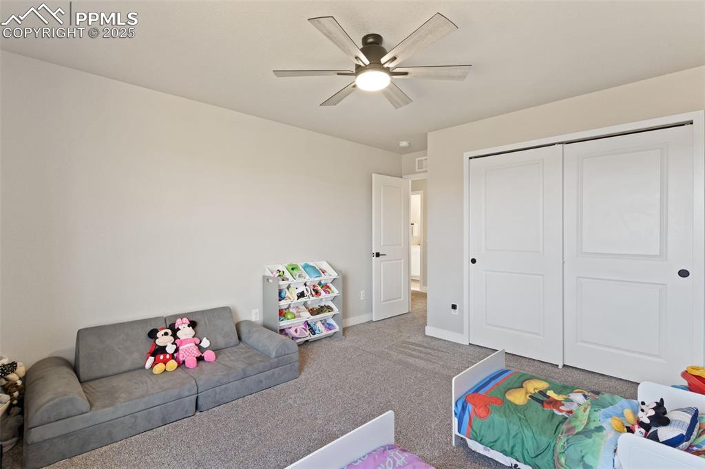 Image 21 of 26: Game room with carpet floors and ceiling fan
