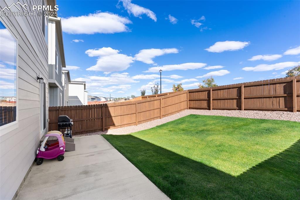 Image 25 of 26: Fenced backyard featuring a patio area