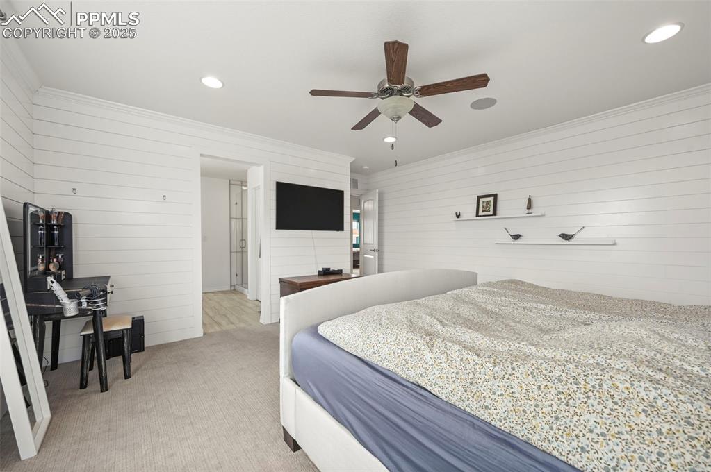 Image 18 of 50: Primary Bedroom with wooden walls looking into the primary bath