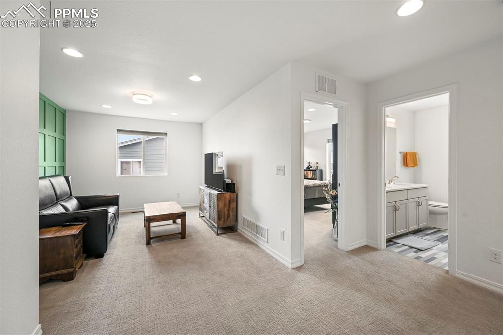 Image 22 of 50: Loft showing proximity to bedroom 2 & bath featuring recessed lighting and 