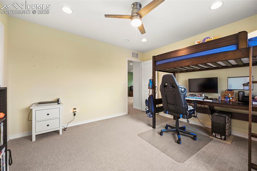 Image 28 of 50: Upstairs Bedroom 3 with a ceiling fan, carpet floors, and recessed lighting