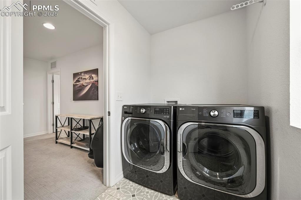 Image 29 of 50: Upstairs Laundry room featuring washing machine and dryer with built in cab