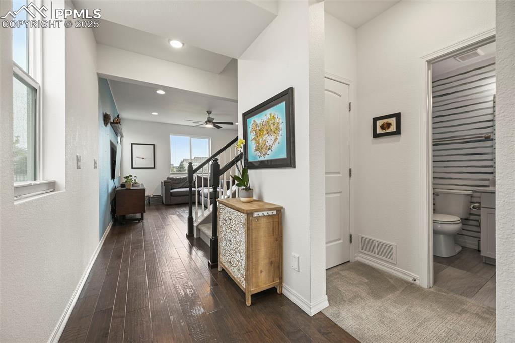 Image 3 of 50: Entry hallway featuring dark wood-style floors and recessed lighting. To th