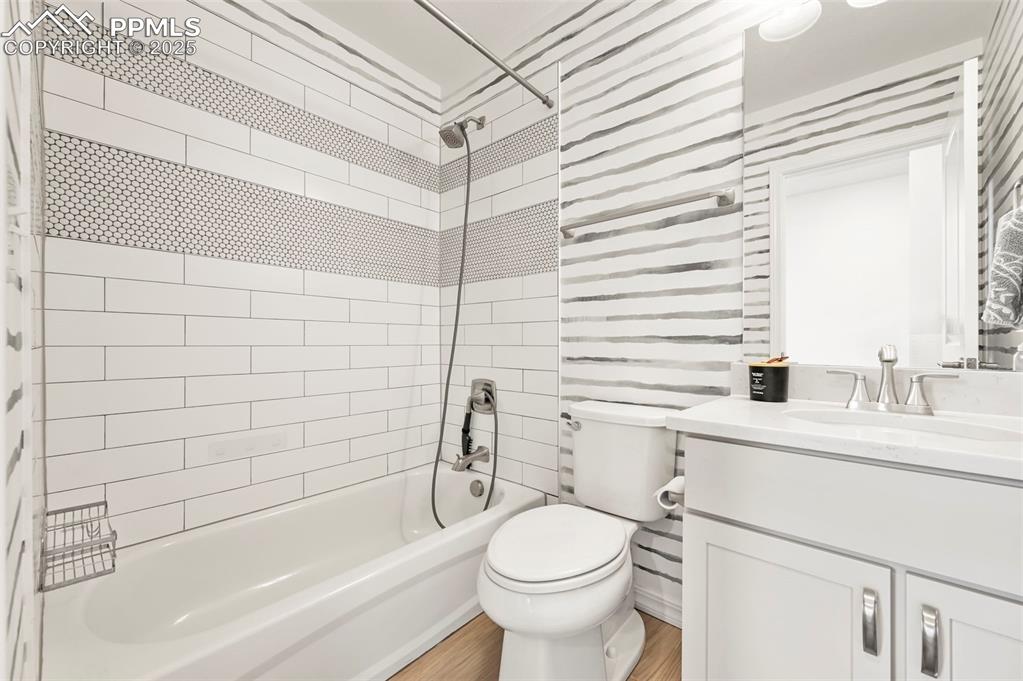 Image 34 of 50: Main level Bathroom with vanity, shower / bathtub combination, and wood fin