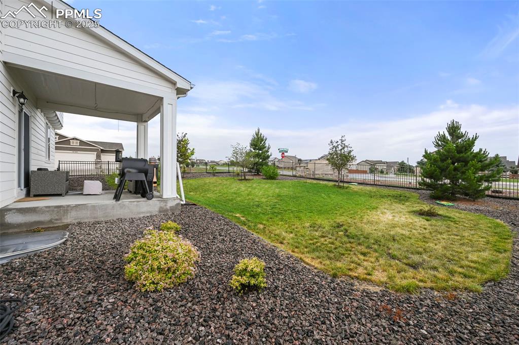 Image 42 of 50: View of yard featuring covered porch