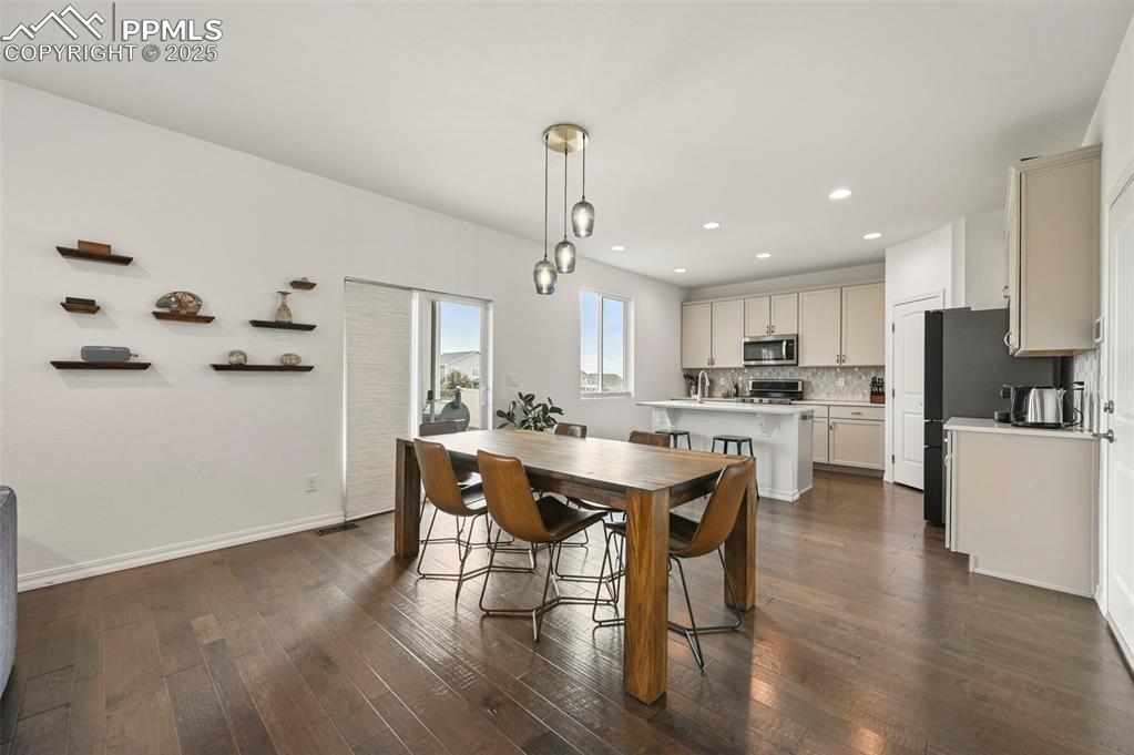 Image 7 of 50: Dining space w/walkout to back patio