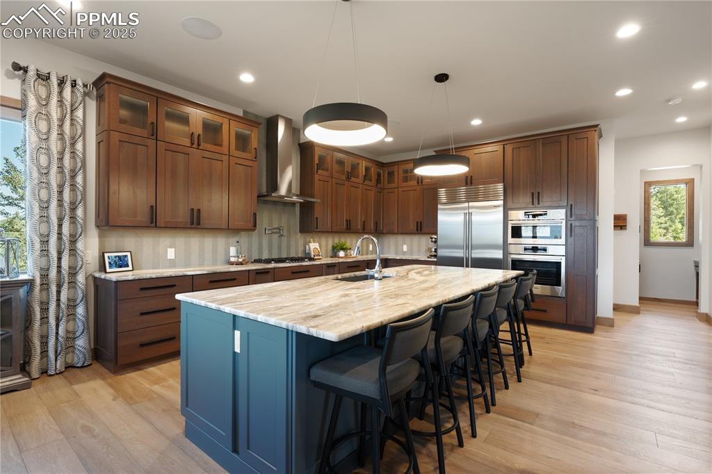 Image 9 of 49: Custom cabinets in the kitchen with two dishwashers and a gas range