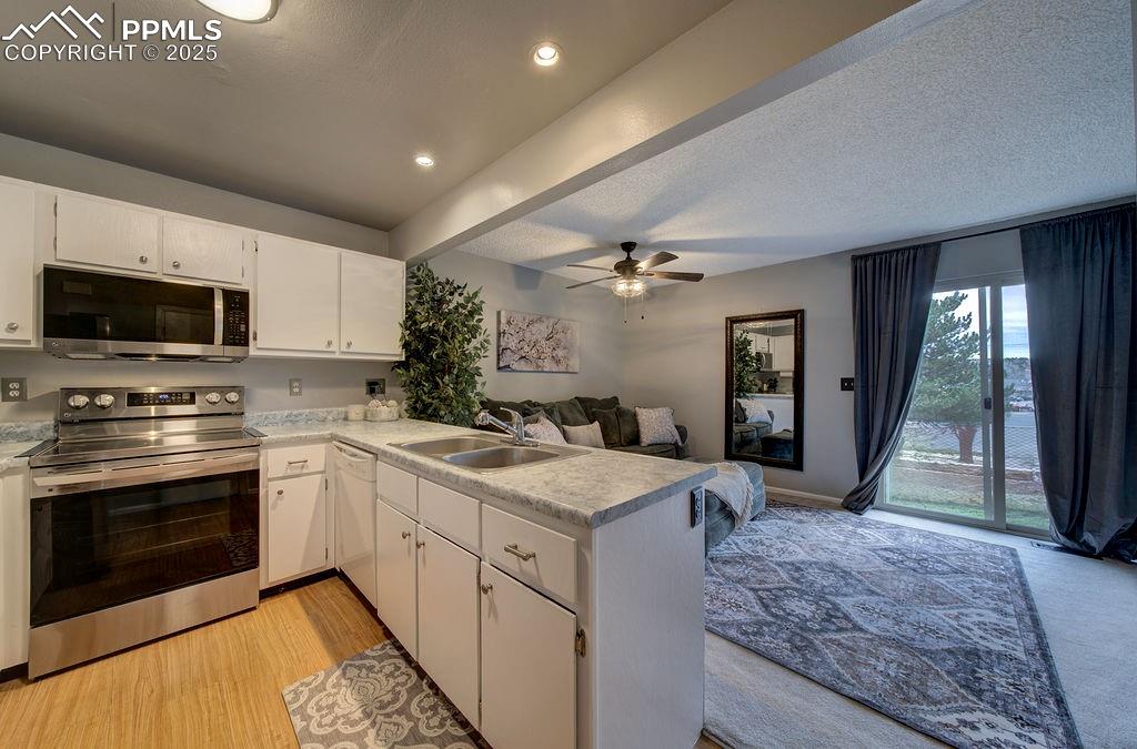 Image 12 of 48: Kitchen featuring appliances with stainless steel finishes, open floor plan