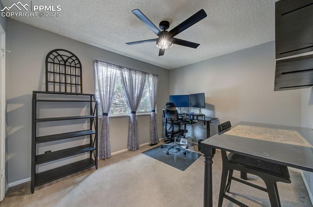 Image 37 of 48: Office featuring light carpet, a textured ceiling, and a ceiling fan