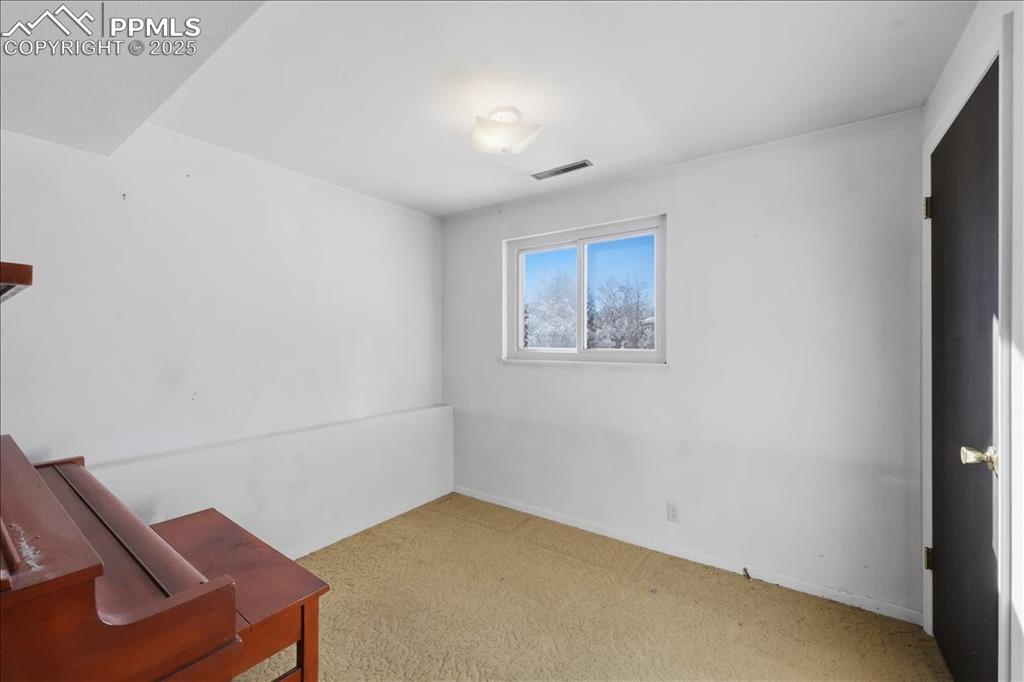 Image 13 of 33: Lower level bedroom.