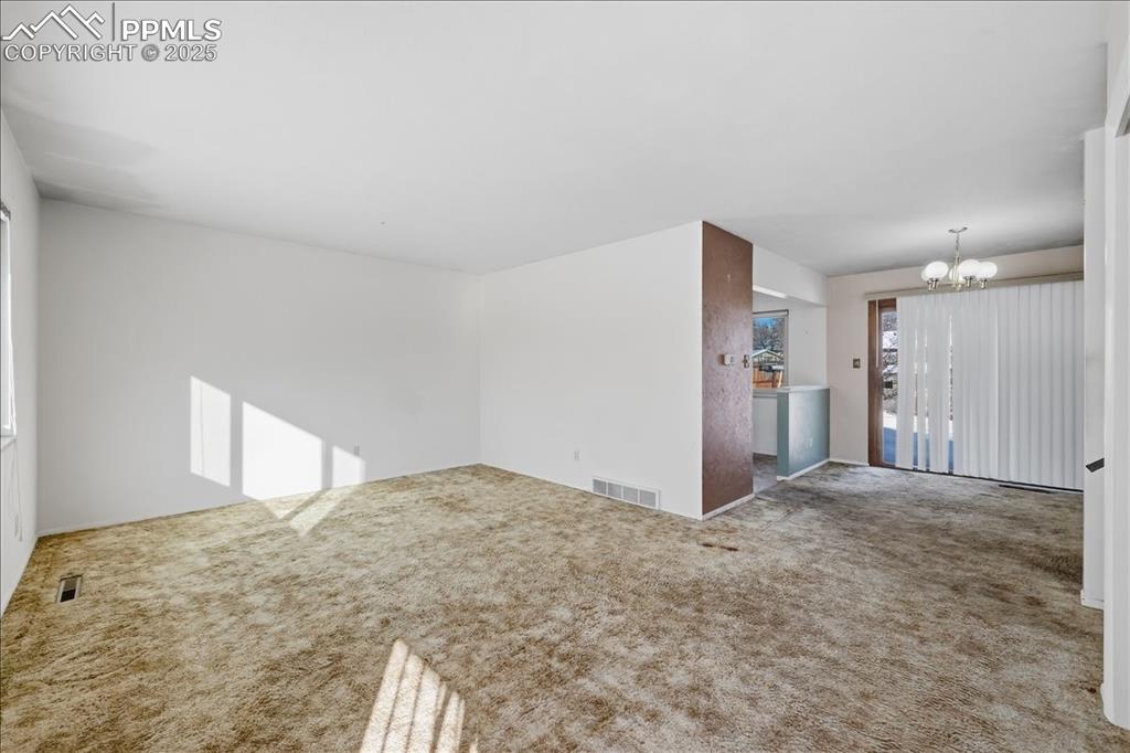 Image 4 of 33: Main level living room and dining area.