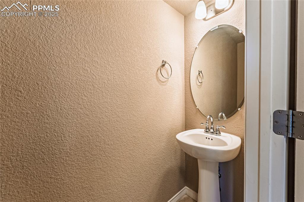 Image 13 of 46: Bathroom featuring a textured wall