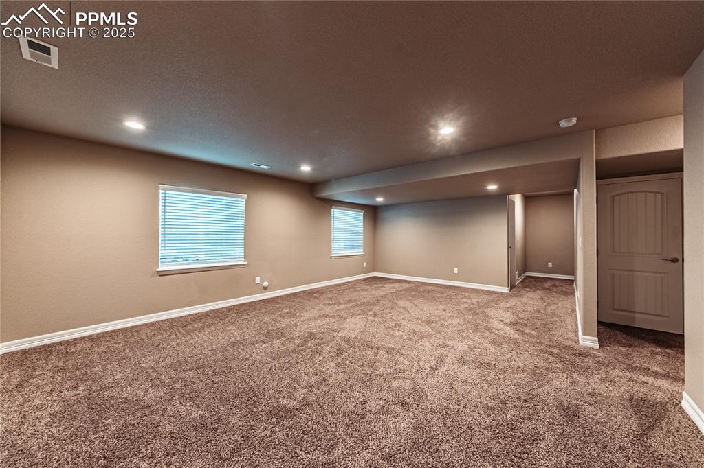Image 33 of 46: Basement featuring visible vents, baseboards, recessed lighting, and carpet