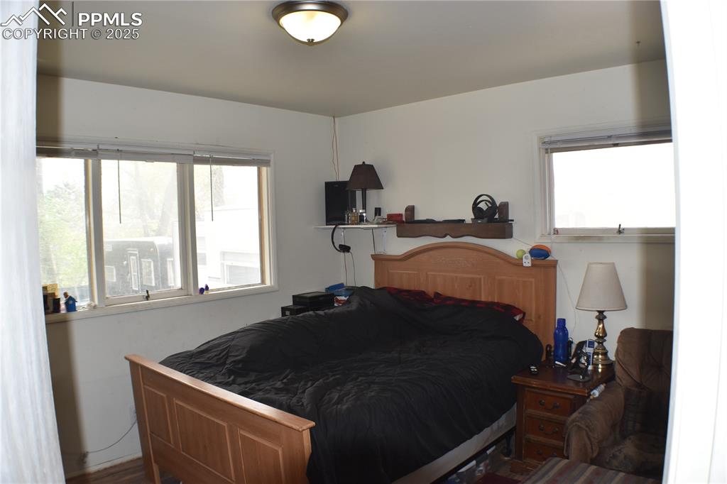Image 15 of 31: Bedroom with multiple windows