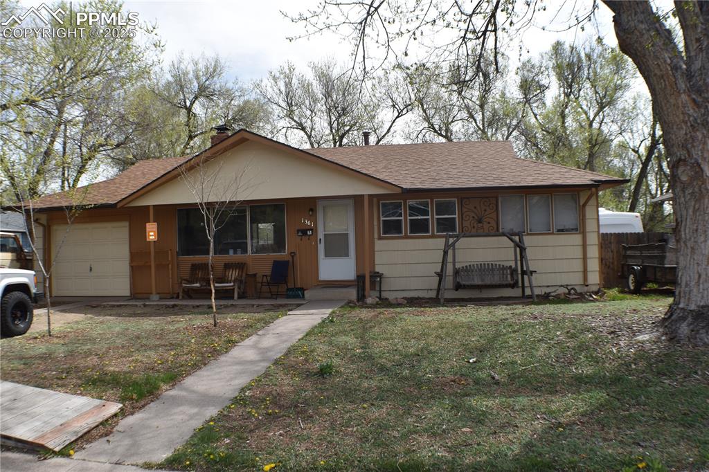 Image 2 of 31: Single story home featuring roof with shingles, a porch, a chimney, fence, 