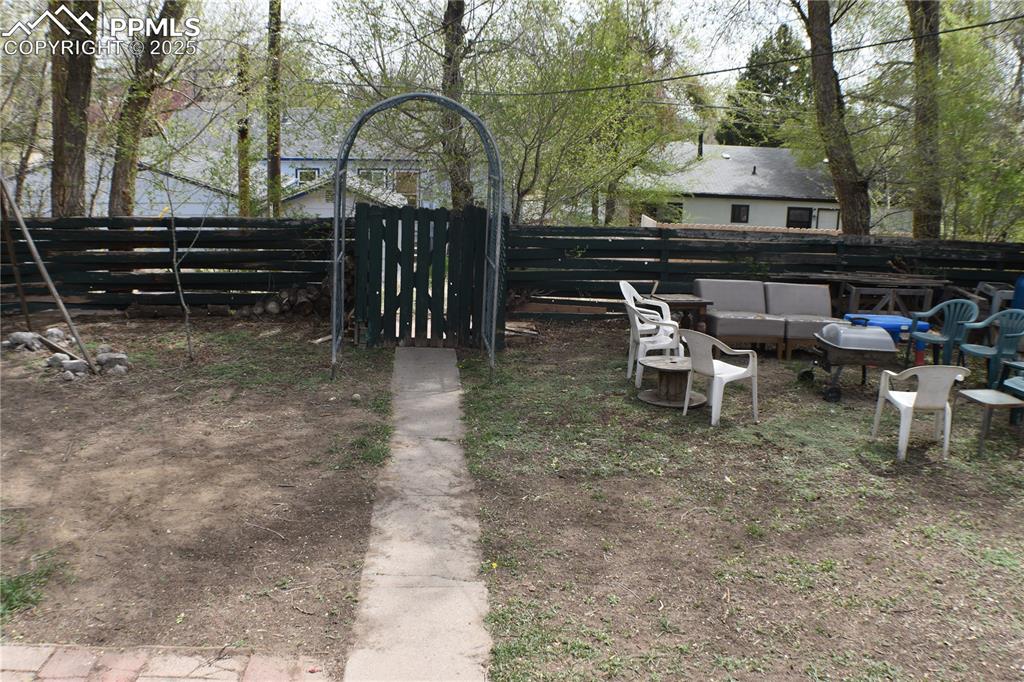 Image 23 of 31: View of yard featuring fence and outdoor lounge area