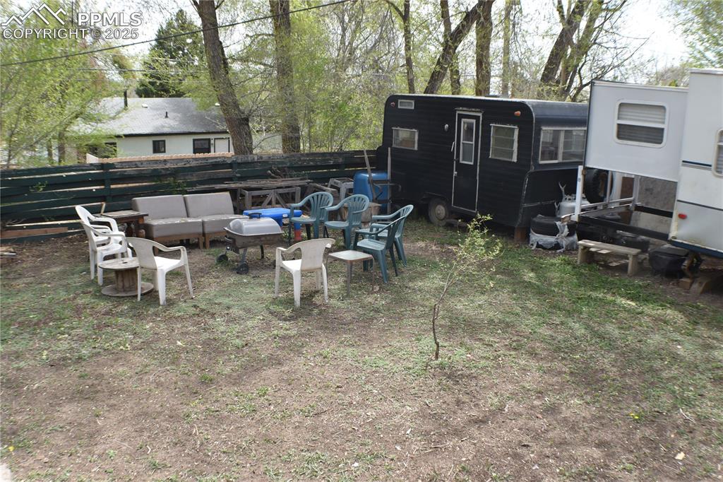 Image 24 of 31: View of yard with fence and an outdoor hangout area
